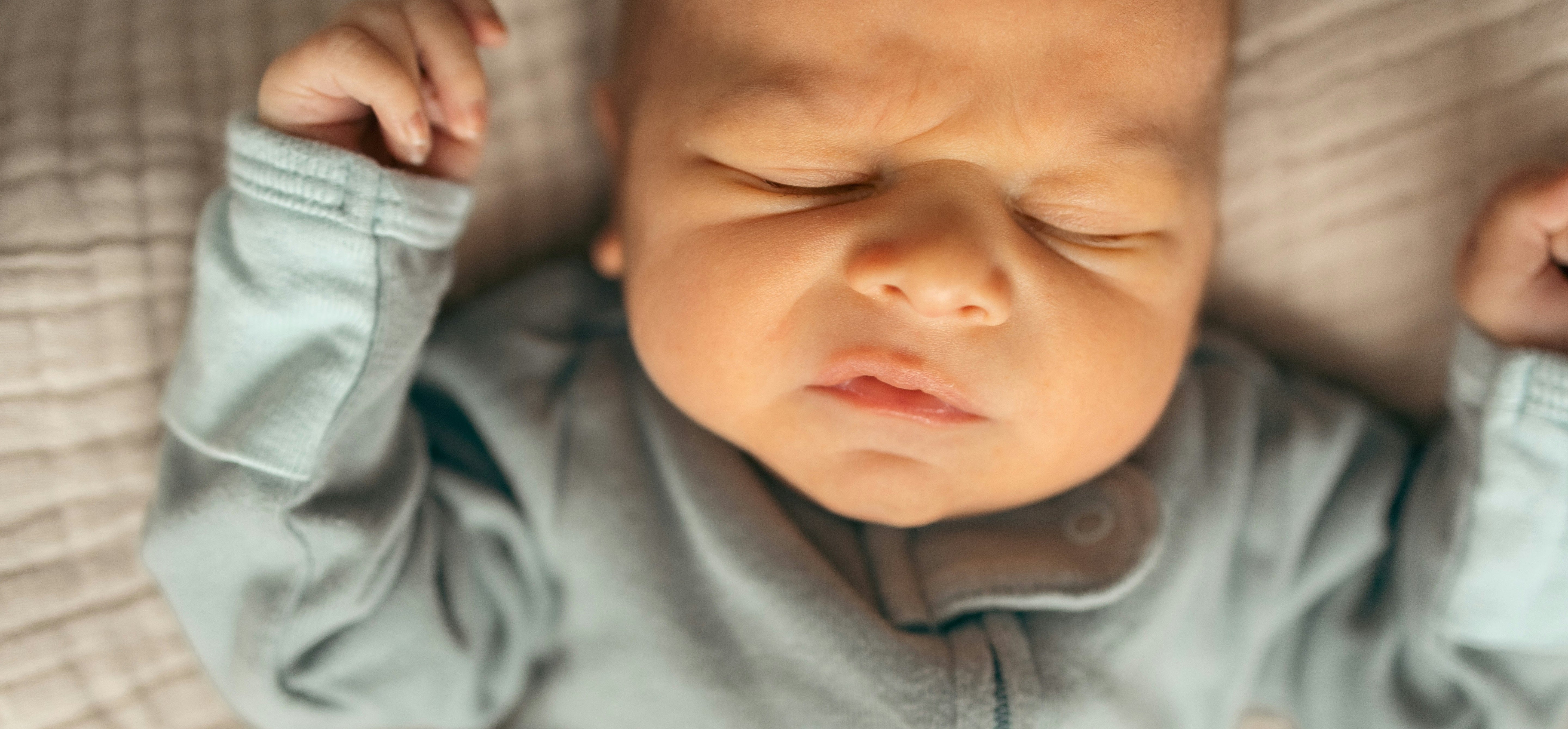 Baby making funny face while sleeping