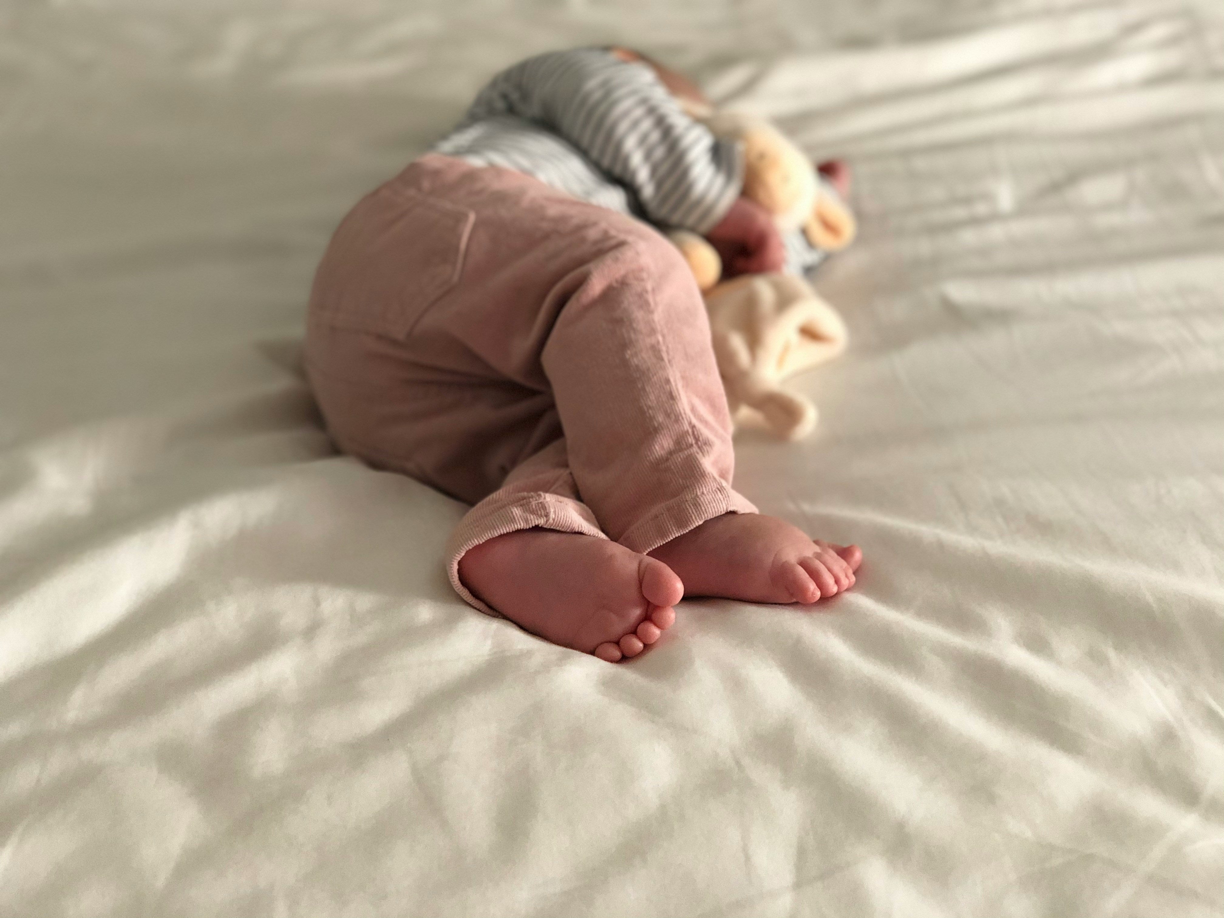 Little baby girl sleeping on bed