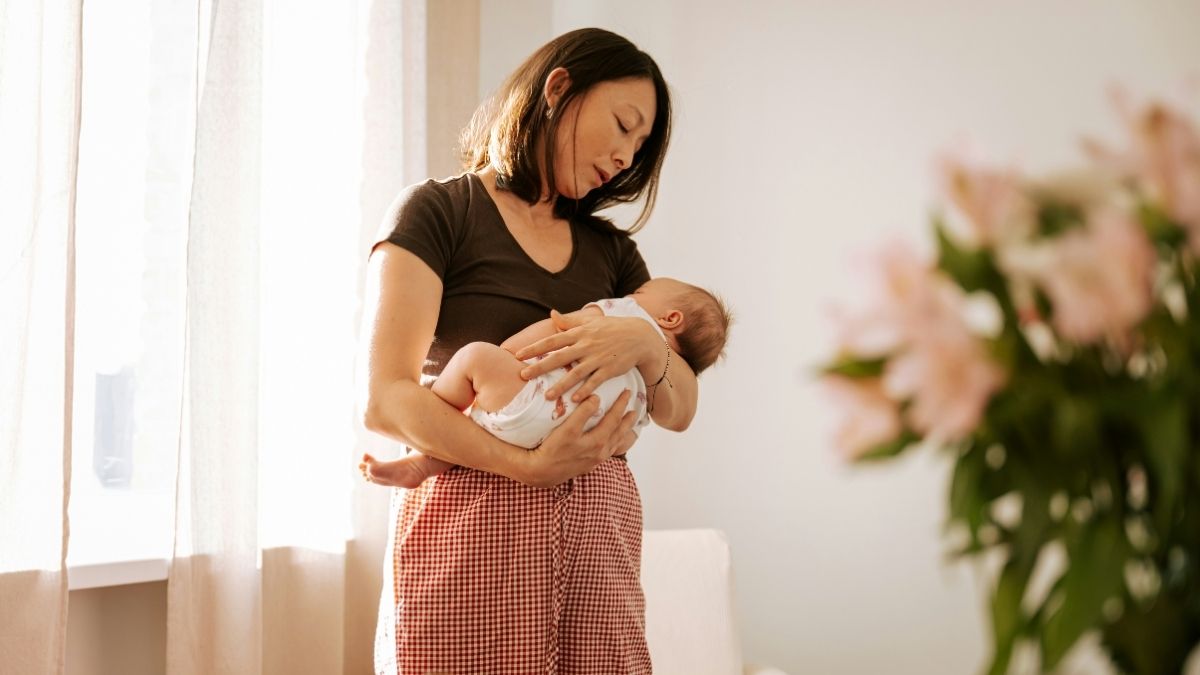 mother gently rocking baby to sleep