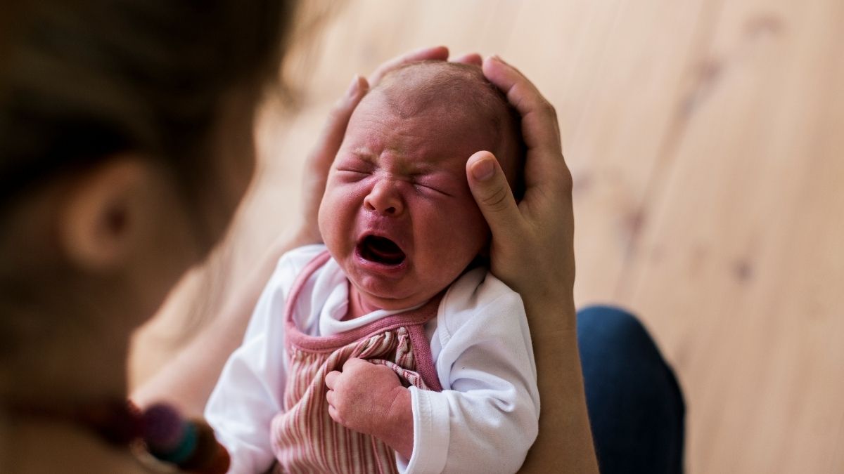 Mother comforting crying baby