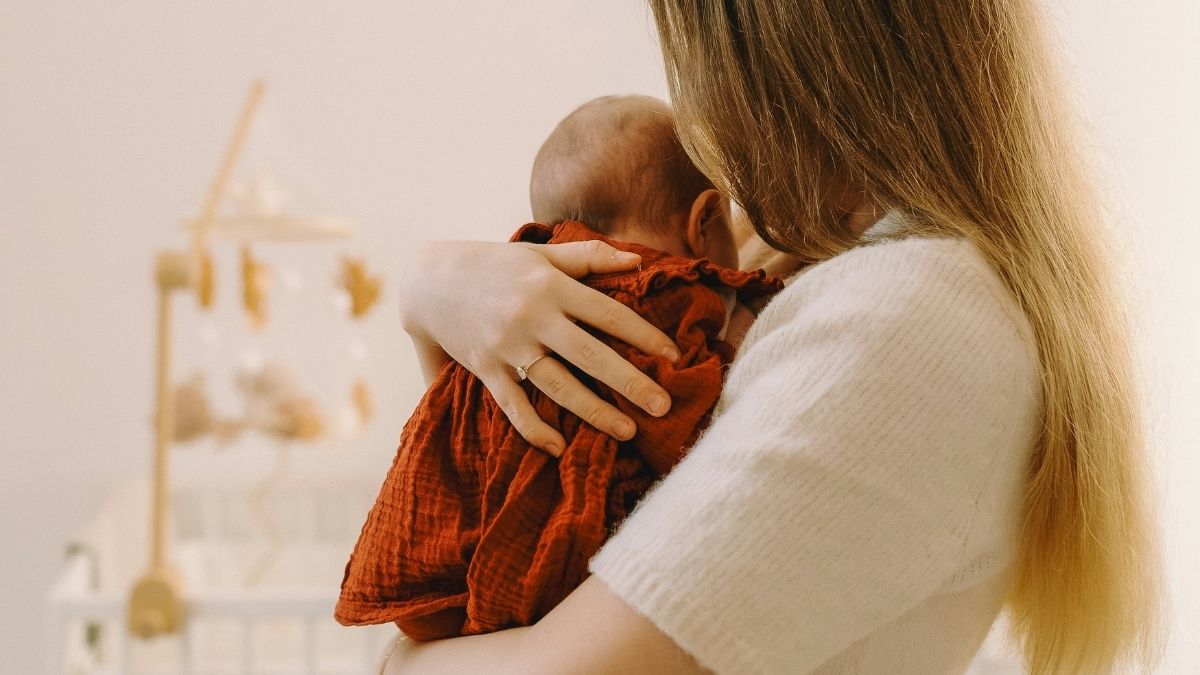 Mother rocking baby to sleep