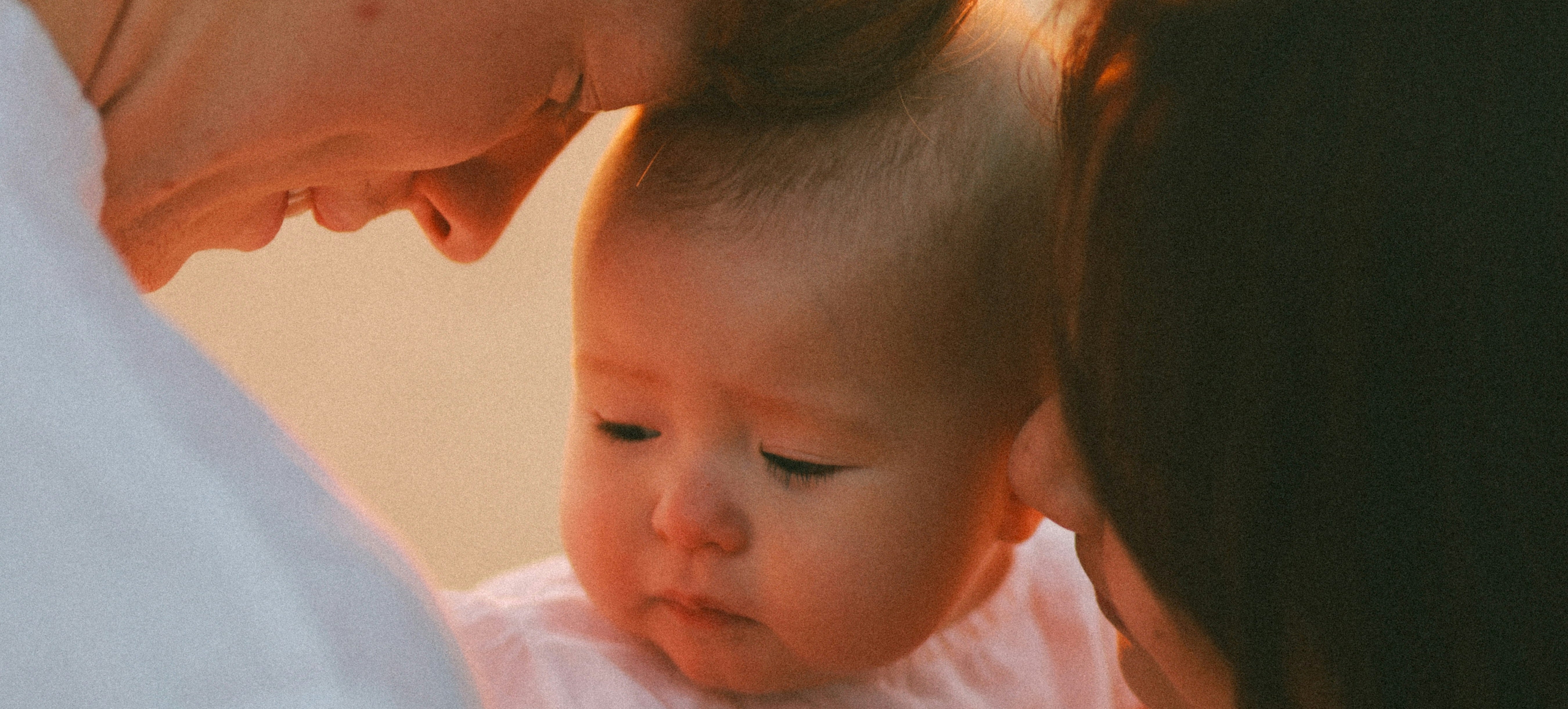 Closeup of parents holding their baby