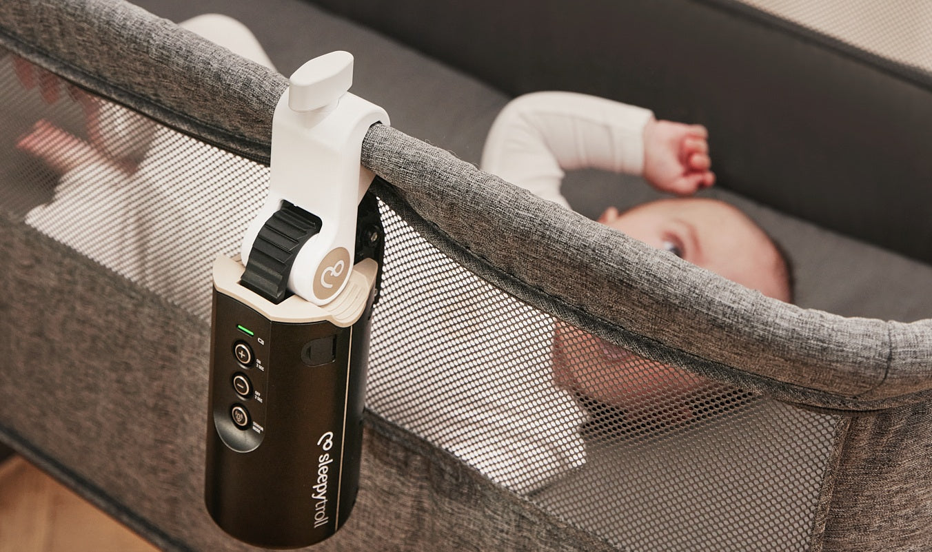 Baby in bedside crib rocked by Sleepytroll Baby Rocker