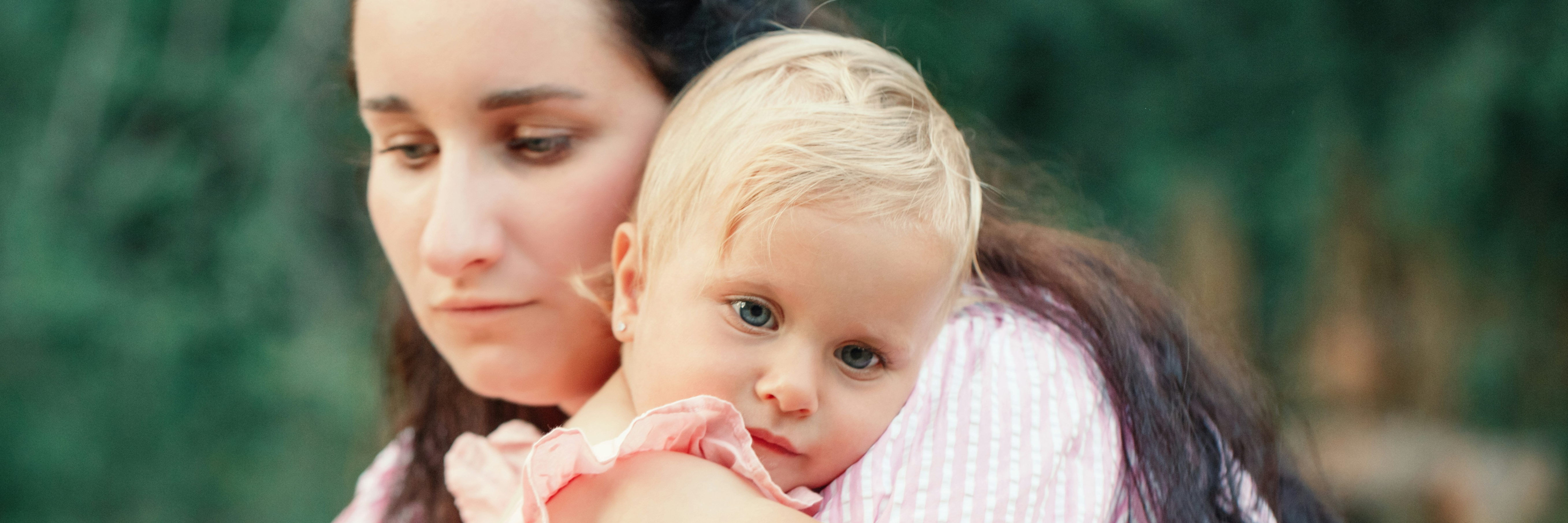Tired mother holding daughter